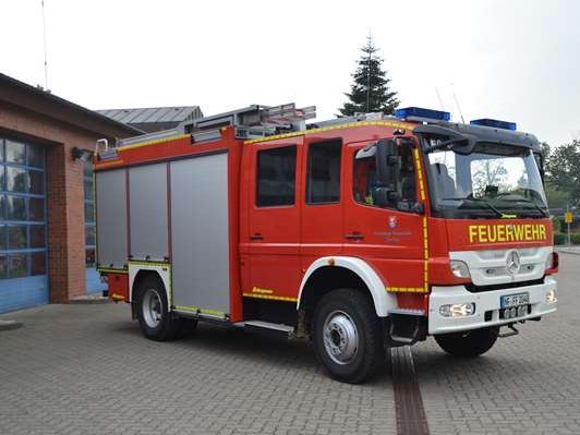 Feuerwehrfahrzeug vor Feuerwehrhaus