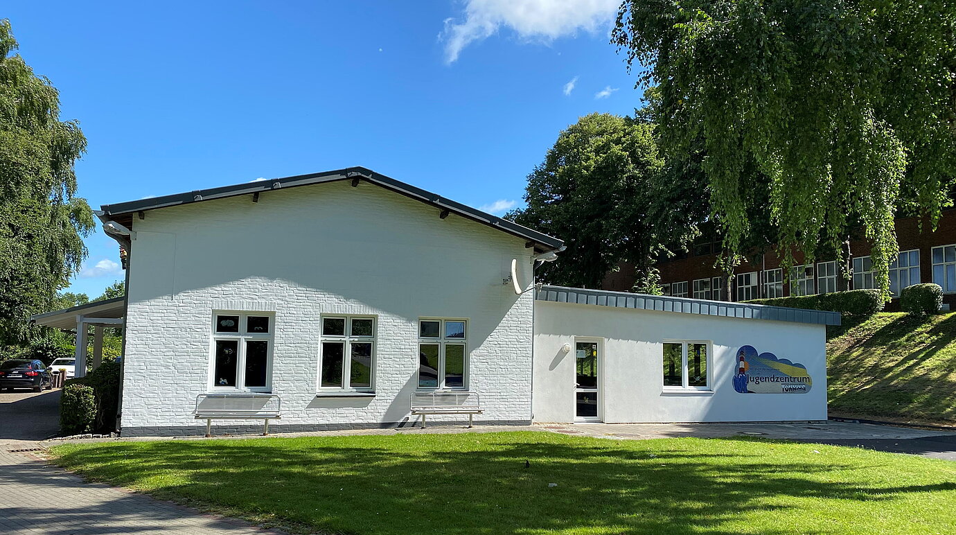 Bild des Tönninger Jugendzentrums bei Sonnenschein mit Logo